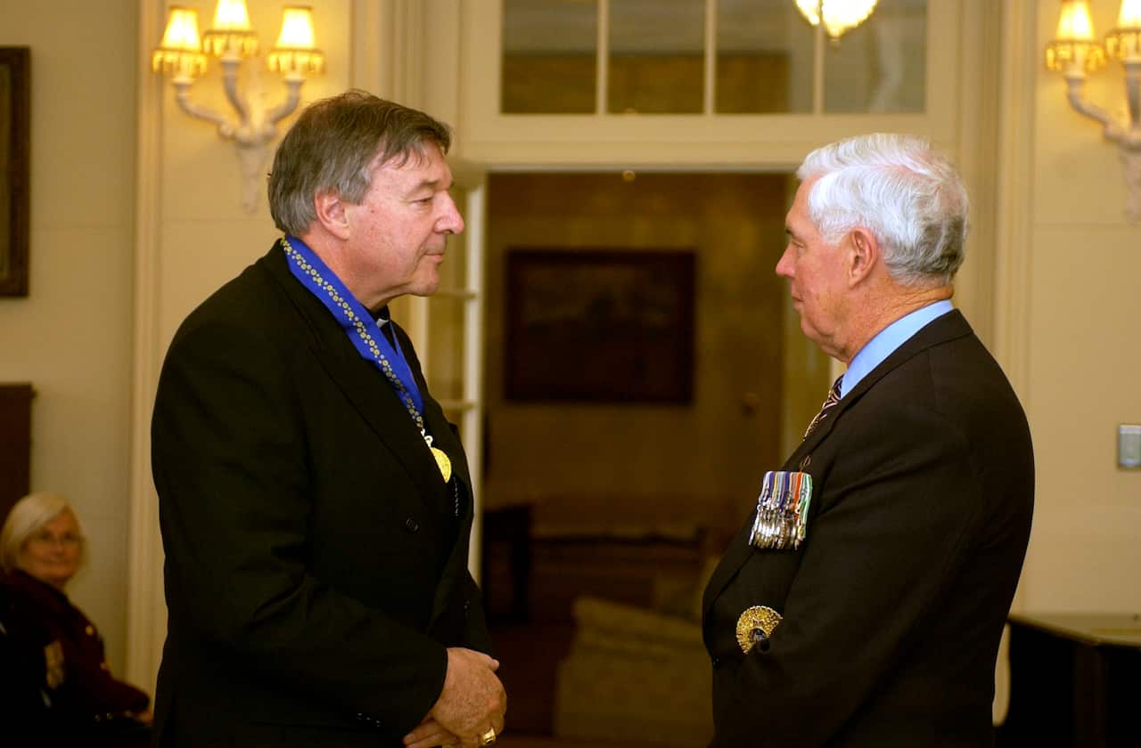 Cardinal George Pell receives the Order of Australia from Governor General Michael Jeffery at Government House Canberra in 2005. 