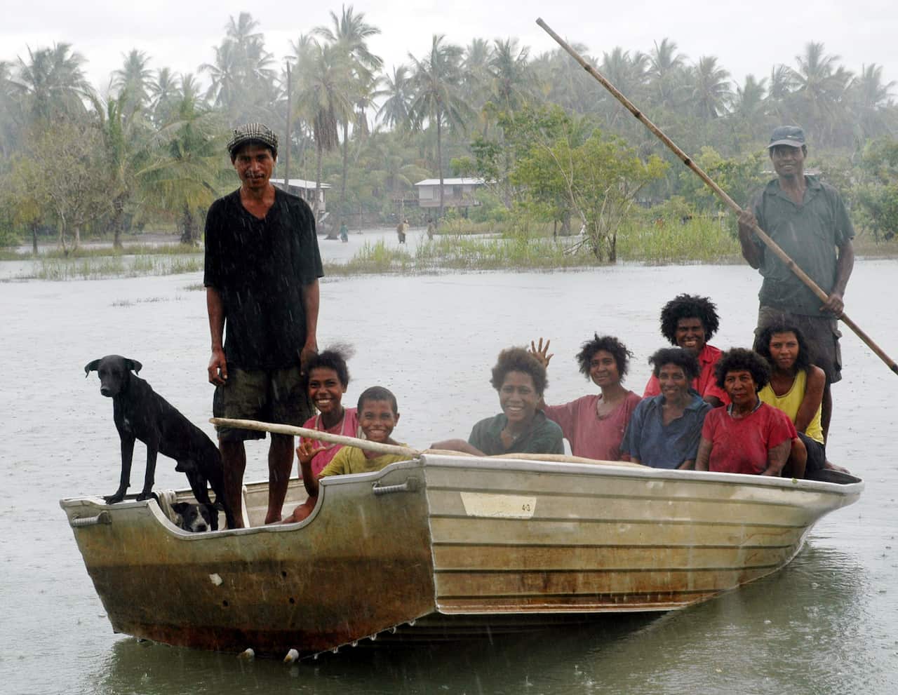 A boatload of residents in their flooded village of Biotou in Papua New Guinea's Central Province.
