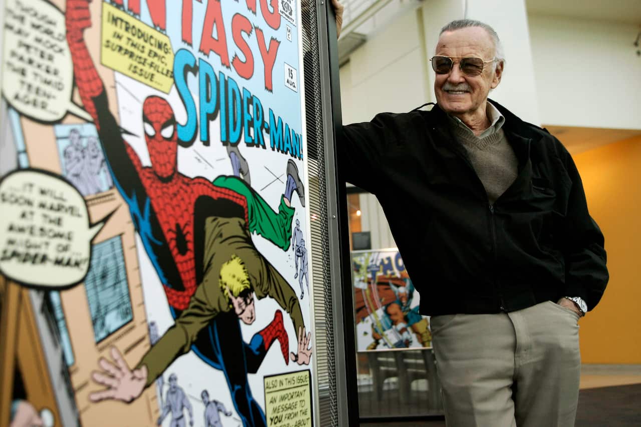 Comic book creator Stan Lee stands beside some of his drawings in the Marvel Super Heroes Science Exhibition at the California Science Center in Los Angeles Tuesday, March 21, 2006.