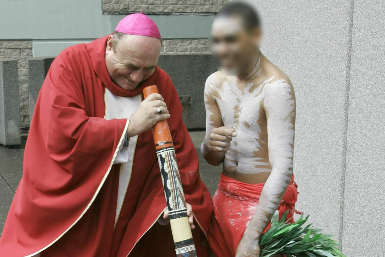 Bishop Saunders attempts to play the digeridoo during World Youth Day 2008 celebrations.