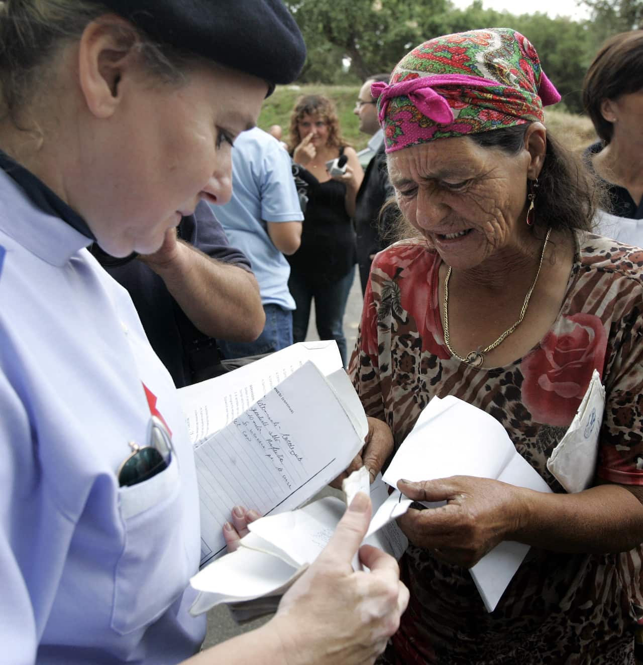 A member of the Roma community speaks to a Red Cross worker