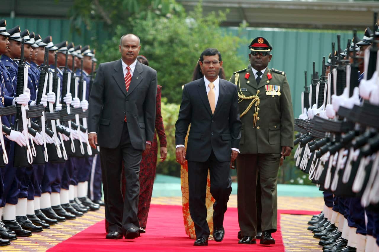 Maldives' first democratically elected president Mohamed Nasheed, center, inspects a guard of honor during the swearing-in ceremony of the president in Male, Maldives, Tuesday, Nov. 11, 2008.