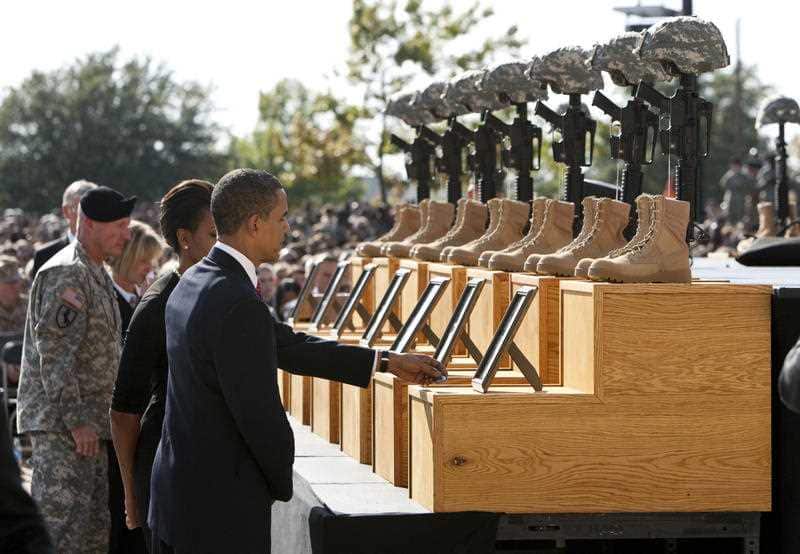 President Obama and First Lady Michelle Obama pay their respects in 2009 at a memorial service at Fort Hood, Texas, for the victims of the Fort Hood shootings 