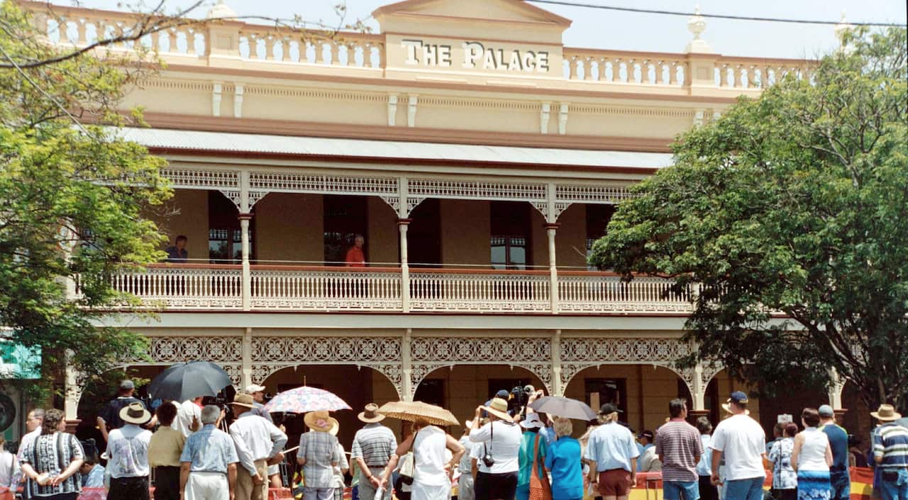 A October 26 2002 file photo of local Childers residents gathering in the main street to attend the Childers Palace Memorial Opening.