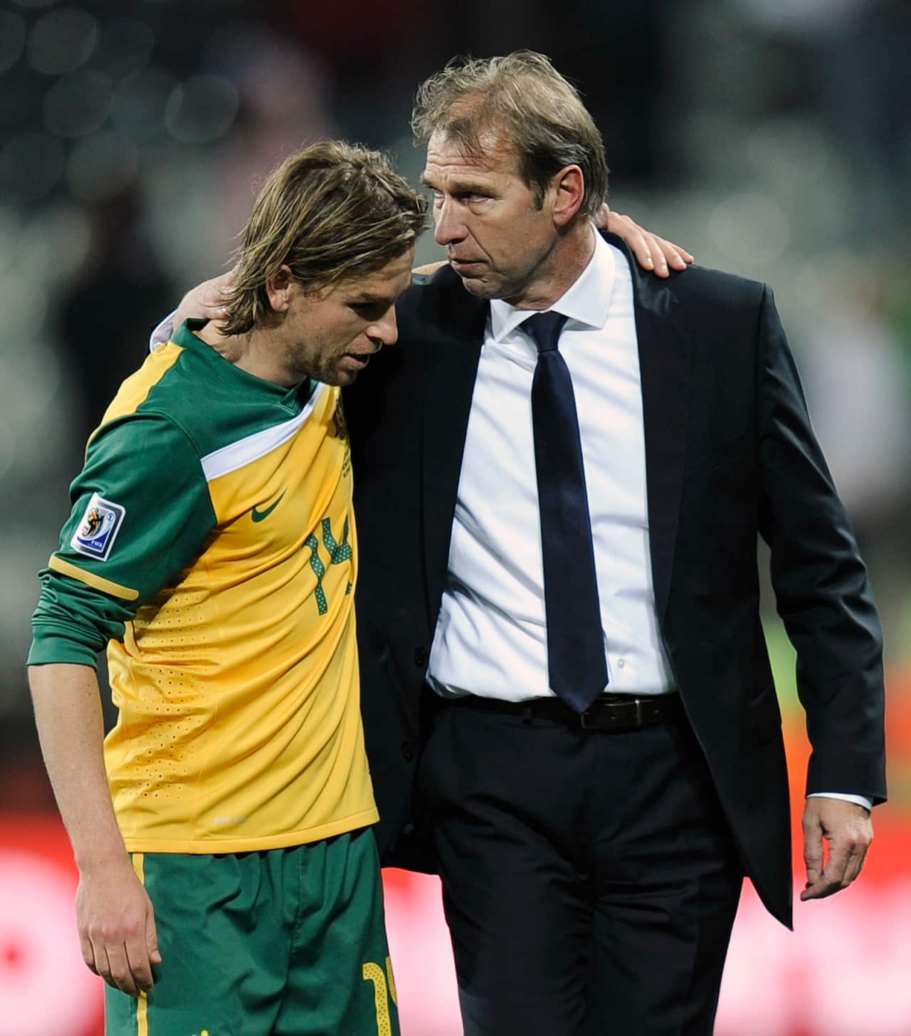 Australia's Brett Holman, left, embraces Australia head coach Pim Verbeek, right, during the World Cup group D soccer match between Australia and Serbia.