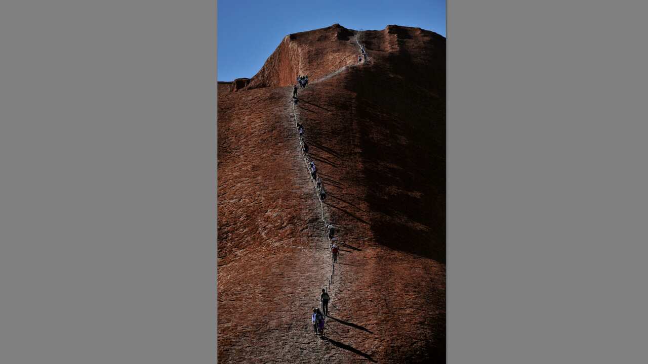 Tourists descend Ulura in the Northern Territory on 11 February 2010.