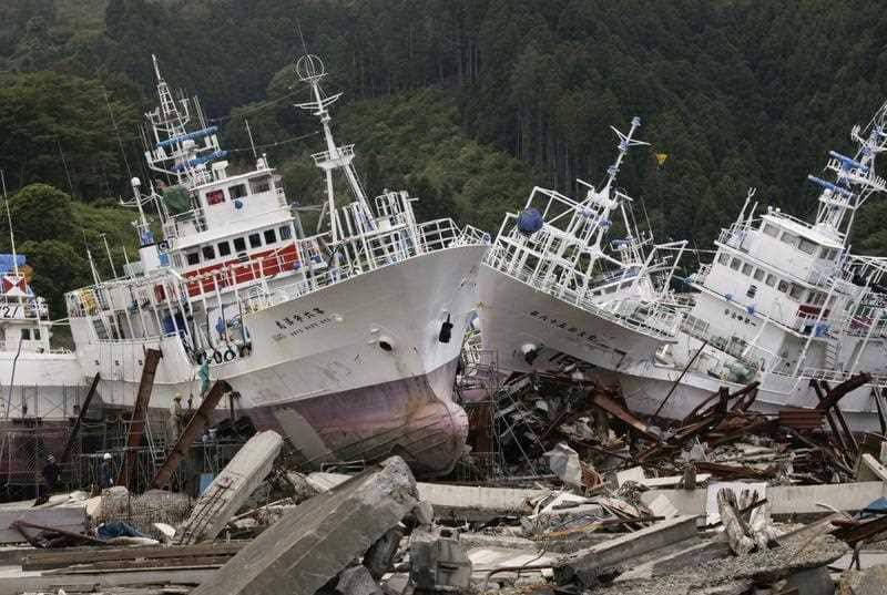 Workers are preparing to remove about 400-ton weight fishing vessels for salmon and saury fishing which were stranded by the tsunami caused of the March 11 magnitude 9.0 earthquake in Kesennuma, Miyagi Prefecture, northern Japan, 15 June, 2011.