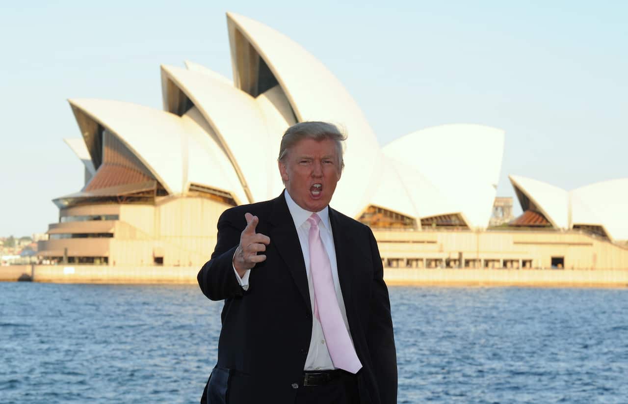 US business magnate Donald Trump poses for a photo in front of the Sydney Opera House, Wednesday, Sept. 21, 2011. Mr Trump is in Sydney to address the National Achievers Congress held this evening. (AAP Image/James Morgan) NO ARCHIVING, EDITORIAL USE ONLY