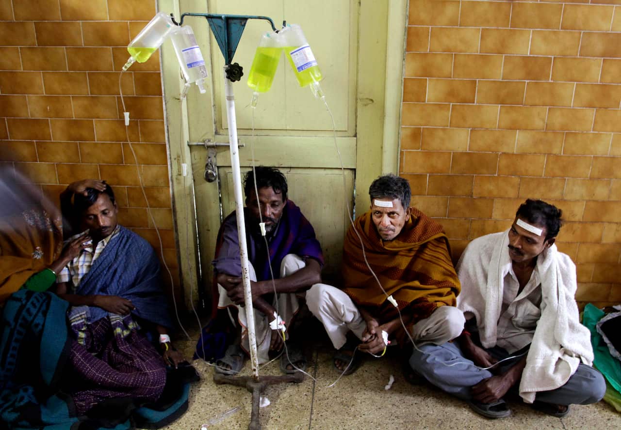 Indian patients take saline as they are treated after drinking toxic alcohol near Kolkata, India.