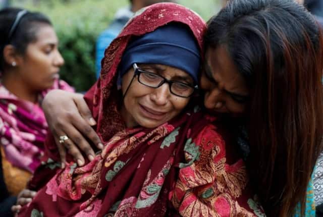 A day after the attack a woman waiting for news about missing loved ones reacts at a community centre near Masjid Al Noor.  