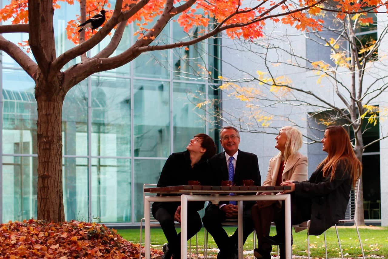 Wayne Swan and his children observe a magpie at Parliament House.