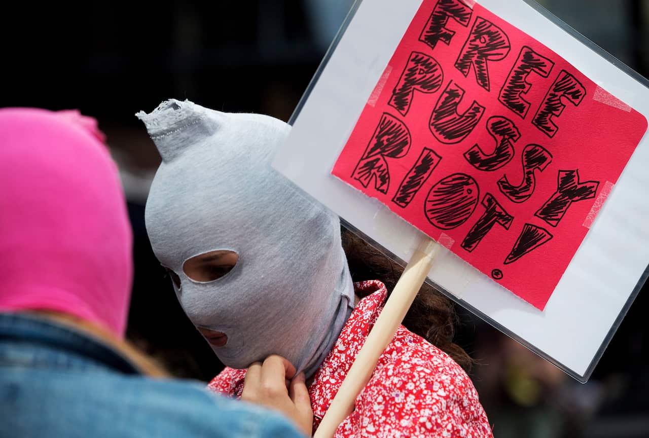 A supporter of the Russian female punk band "Pussy Riot" sports a mask during a protest outside the Russian consulate in Toronto