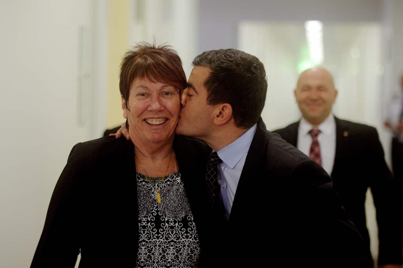 Senator Sam Dastyari (right) kisses Senator Sue Lines as they arrive for a Labor Caucus meeting at Parliament House in Canberra, Monday, Nov. 11, 2013. The 44th Parliament will be officially opened tomorrow. (AAP Image/Lukas Coch) NO ARCHIVING
