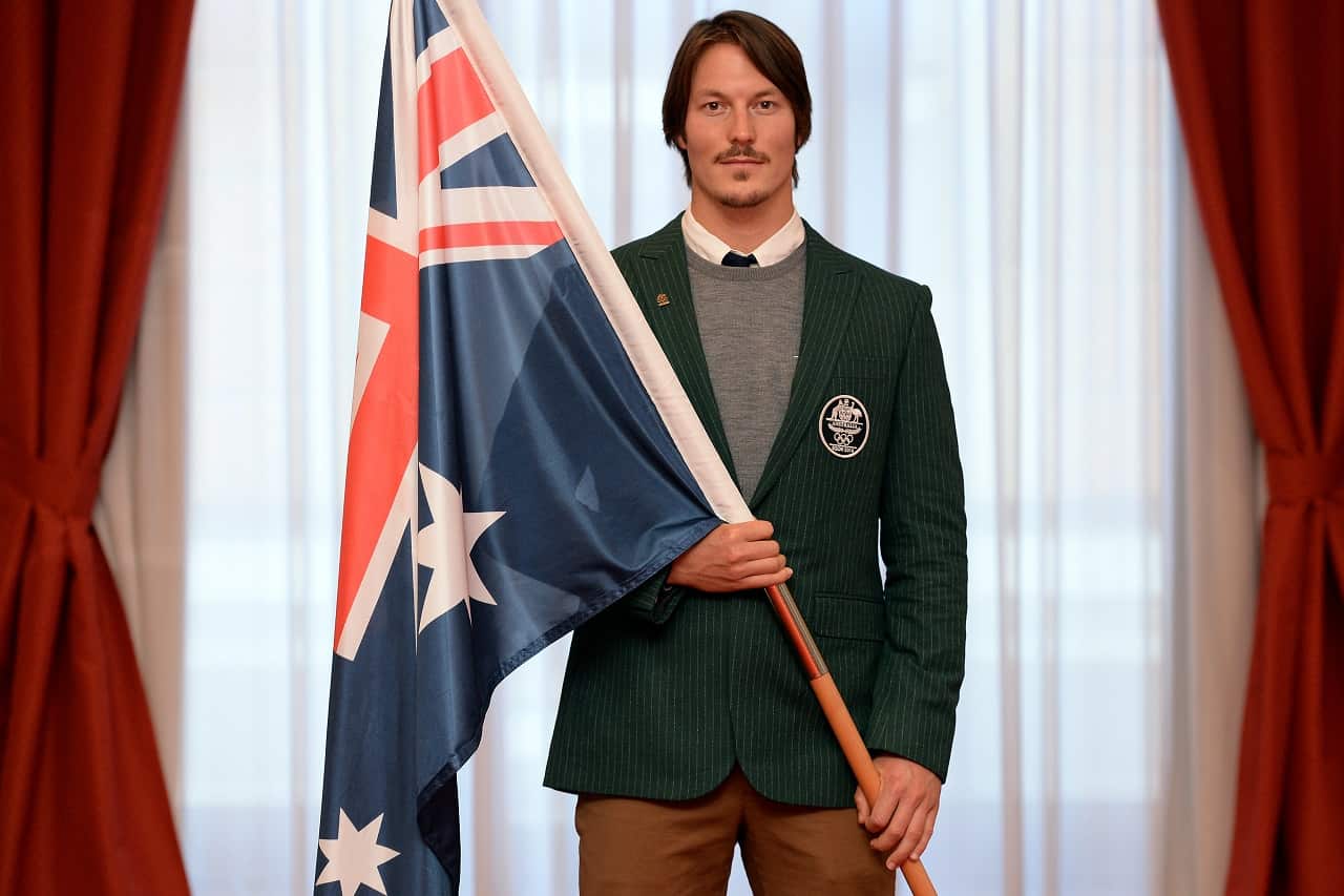 Alex Pullin holds the national flag before the Sochi Winter Olympics.