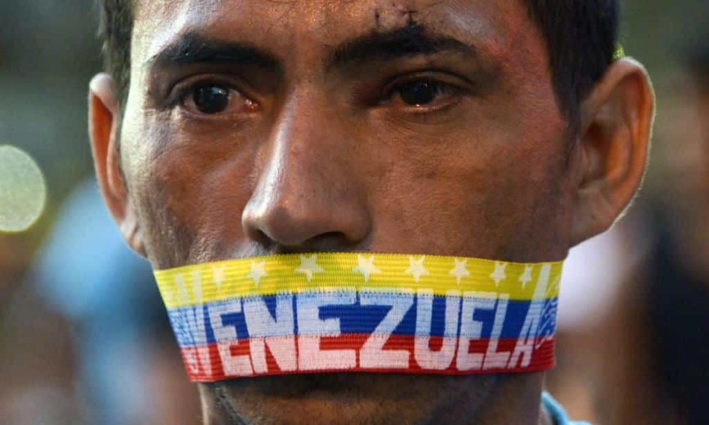 A man attends a protest against the government of Venezuelan President Nicolas Maduro in Caracas on February 23, 2014. (AAP)