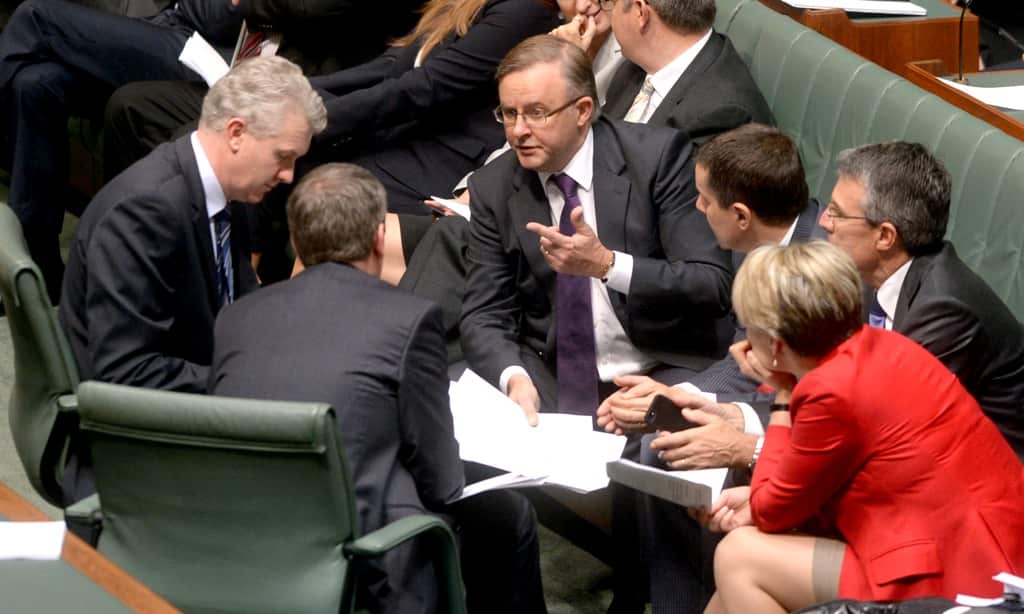 Opposition front bench members gather for a conference during a division in the Qantas Sale Act debate in the House of Representatives chamber in Canberra, Thursday, March 6, 2014. (AAP)
