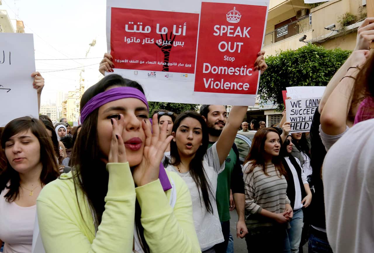 Women hold placards during a rally, notably to denounce domestic violence, on the "International Women's Day" on March 8, 2014 in front of the National Museum in the capital Beirut. (AAP)