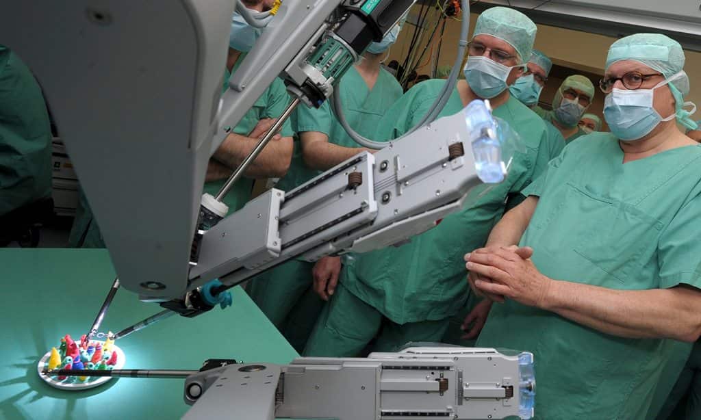 A surgical robot in an operating room at the University Hospital in Halle (Saale), Germany, 17 March 2014. (EPA)