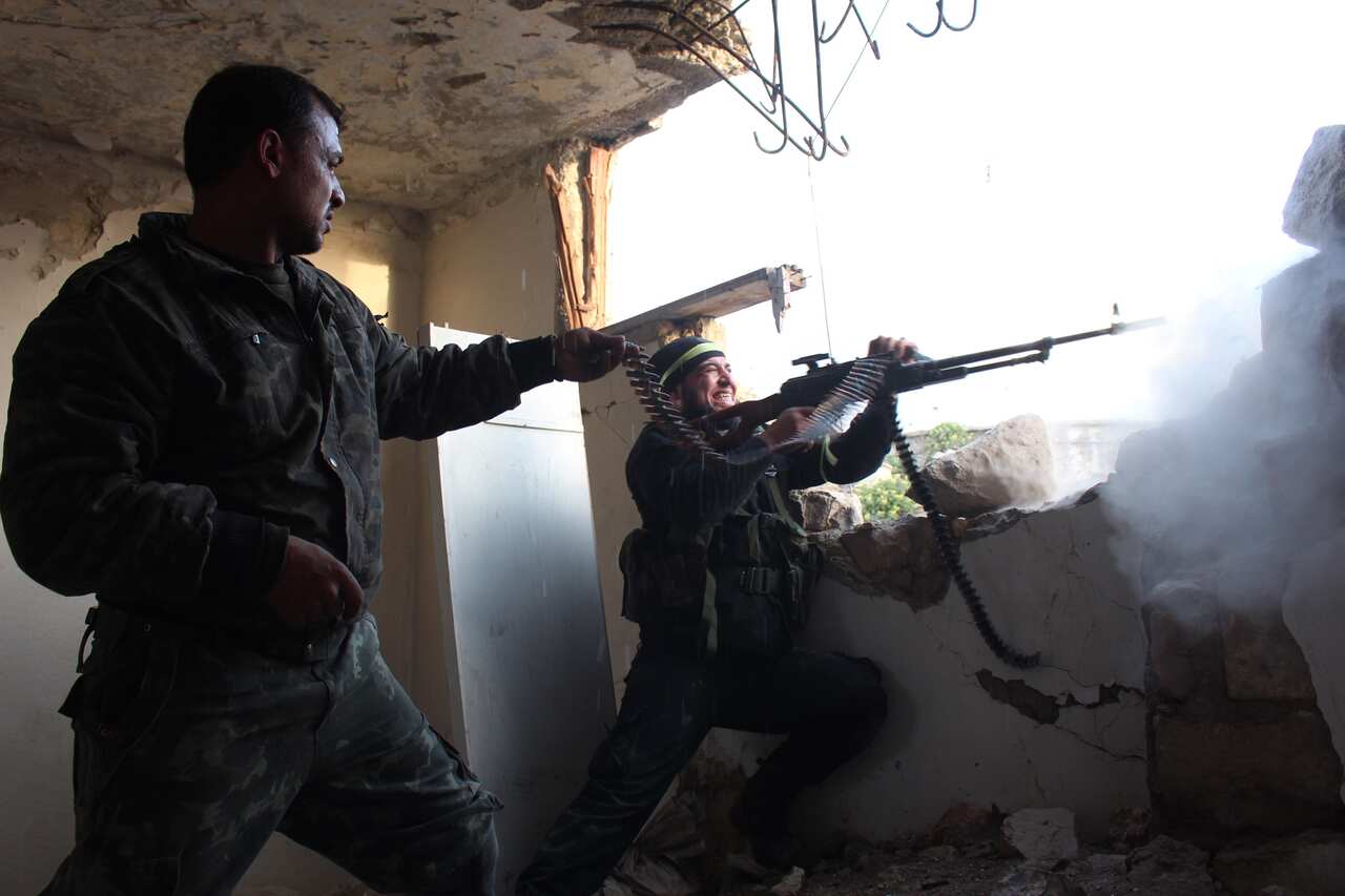 Rebel fighters fire a machine gun during clashes with pro-government forces on March 18, 2014 in the northern Syrian city of Aleppo. (AAP)