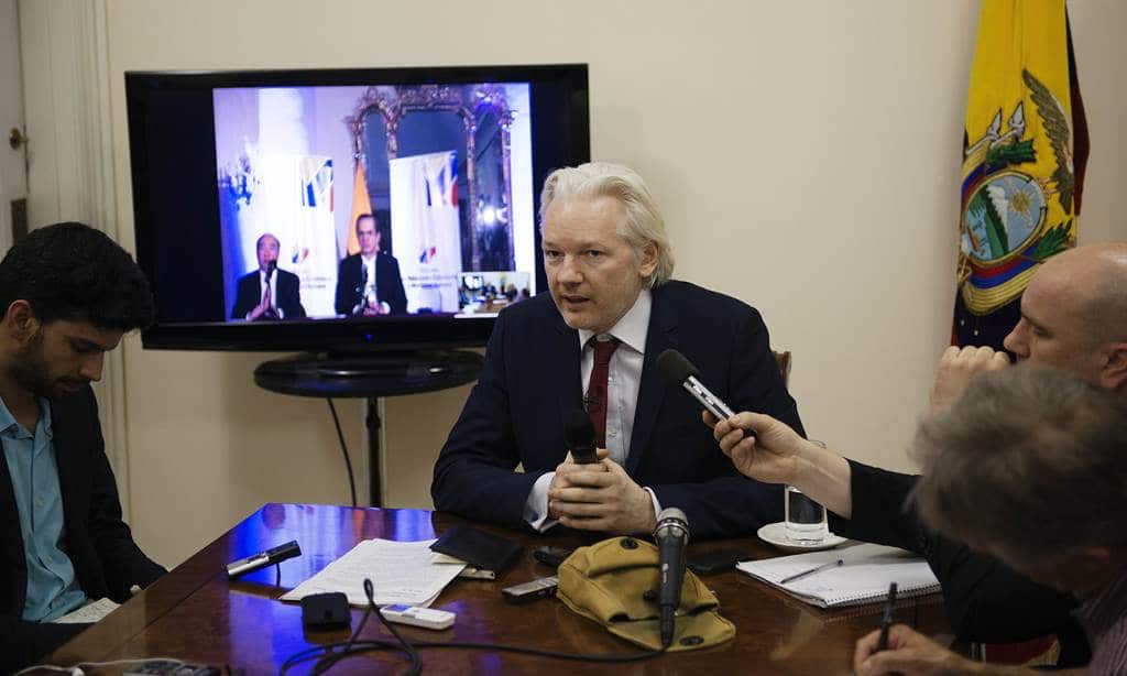In a handout picture released by Sunshine Press Productions on June 19, 2014 WikiLeaks founder Julian Assange speaks to members of the media during a press conference inside the Ecuadorian Embassy on June 19, 2014. (AFP)