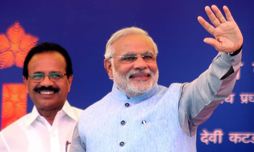 Indian Prime Minister Narendra Modi (r) waves to the gathering as railway minister D. V. Sadananda Gowda (l) stands next to him during the inaugural function of the first train Shree Shakti Express. (EPA)