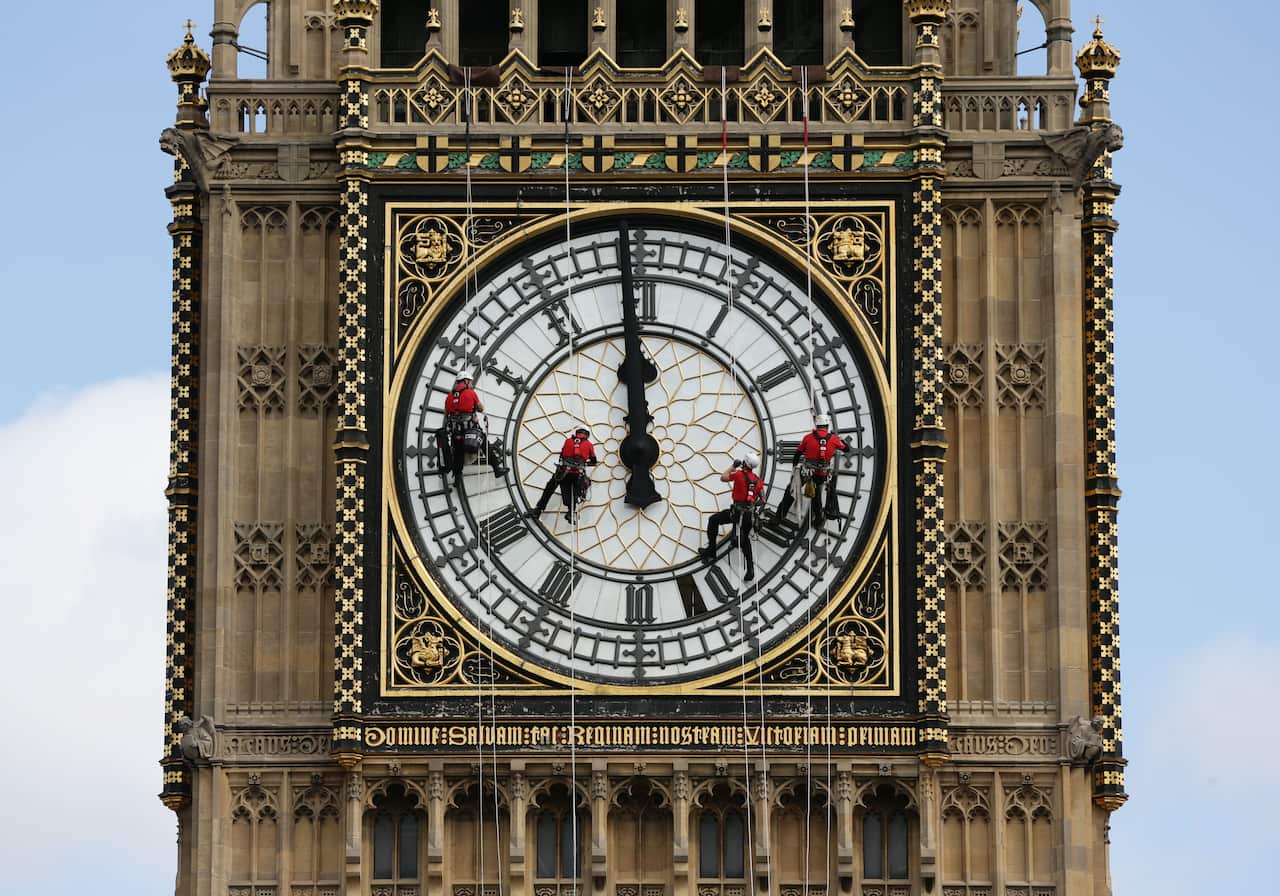 An abseiling team clean Big Ben