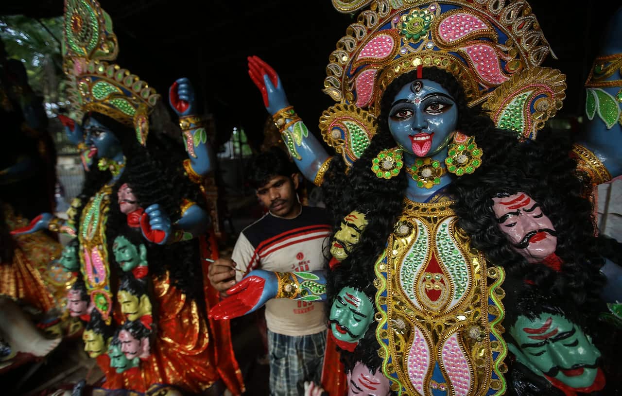 An Indian artist gives finishing touches to the idols of Goddess Kali, who will be worshipped during Diwali festival. (EPA/DIVYAKANT SOLANKI)