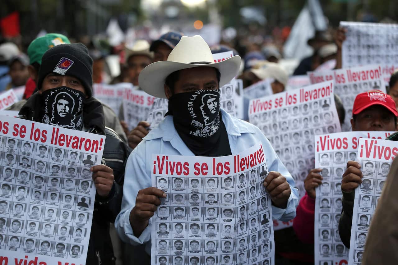 Protesting the disappearance of 43 Mexican students. The signs read "They took them alive".