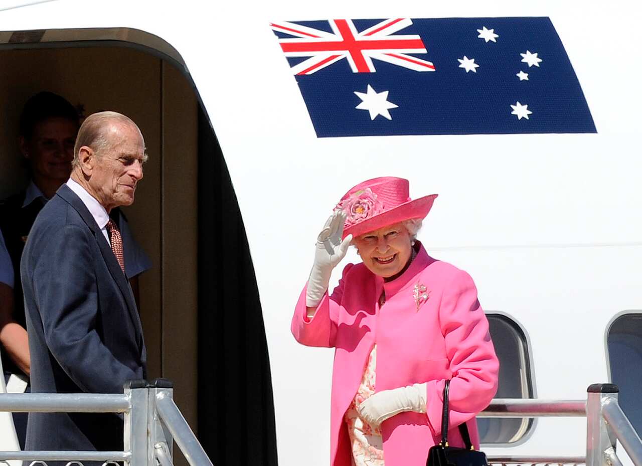 Britain's Queen Elizabeth II, right, and her husband Prince Philip, board a plane flying to Perth from Melbourne airport, October 2011.