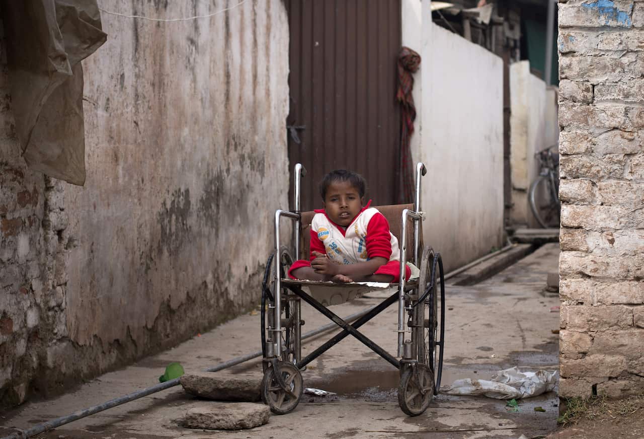 Sharjeel, who is paralysed due to polio, sits outside his home in Islamabad, Pakistan. While vaccine distrust has sparked debates amid a measles outbreak in the United States, Pakistan is in a deadly battle to wipe out polio. (AP Photo/B.K. Bangash)