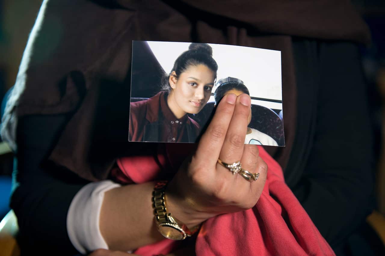 Renu, eldest sister of Shamima Begum holds her sister's photo whilst being interviewed by the media at New Scotland Yard, Central London. 