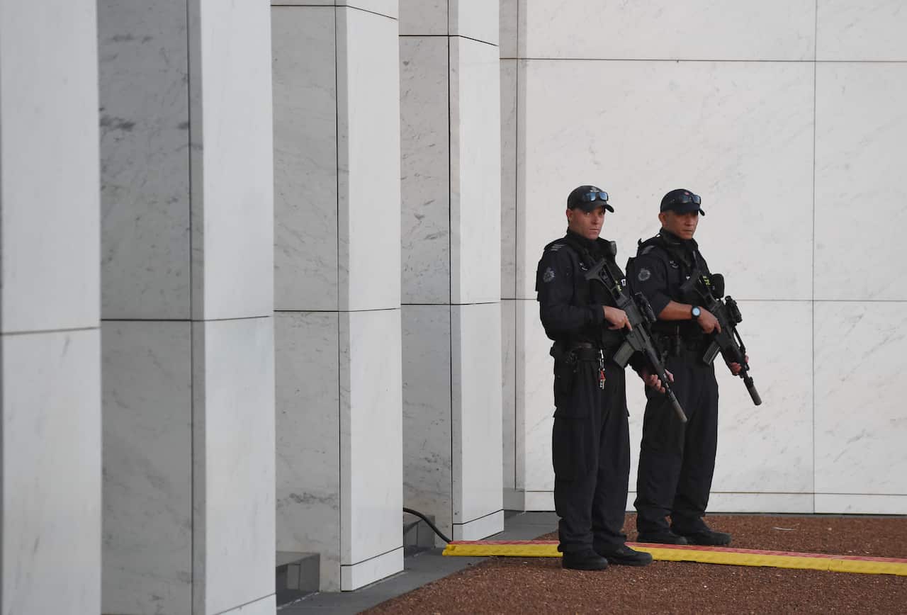 Armed Australian Federal Police officers are seen at Parliament House in Canberra.