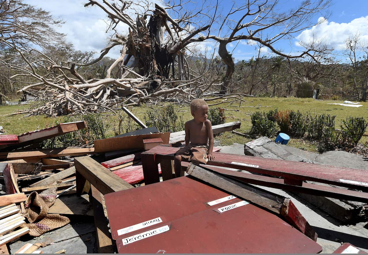 A student sits amonst the remains of his classroom at the Manuapen Primary School, on the remote south-west coast of Tanna Island , Vanuatu