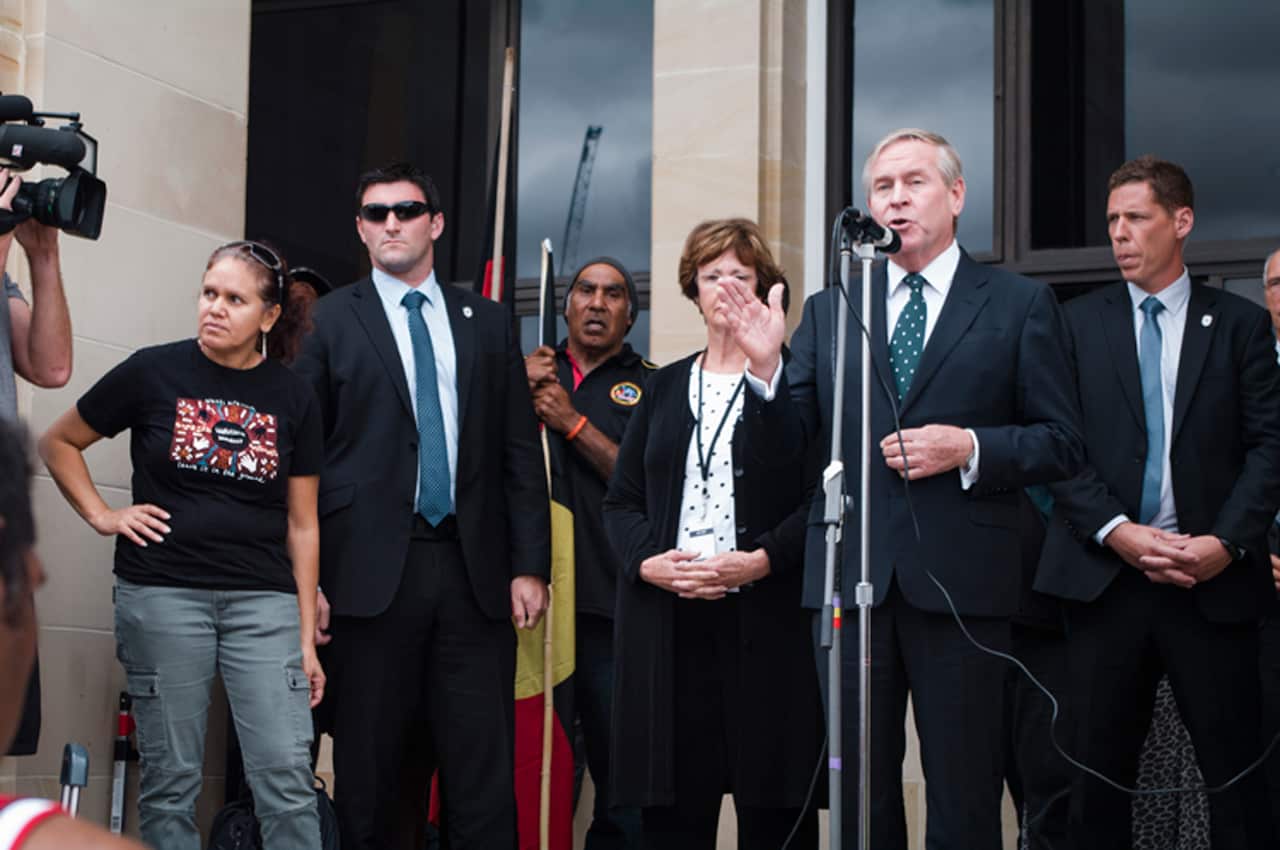 Premier Colin Barnett addresses protesters rallying against the state government's planned closure of more than 100 remote communities. (AAP)