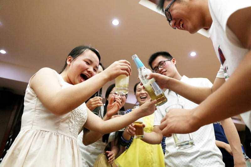 Chinese graduates drink beer at a graduation dinner in Anqing city, east China's Anhui province