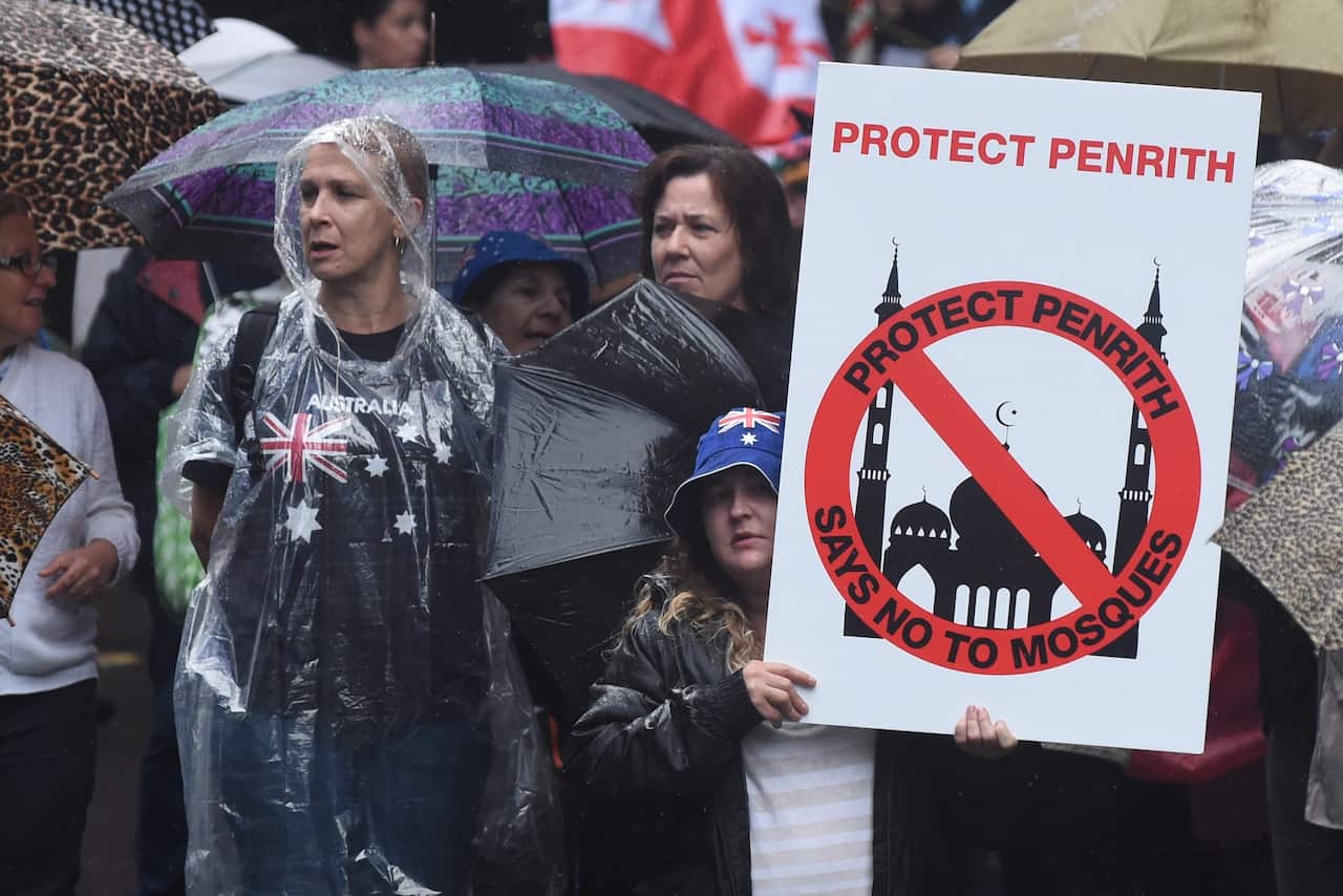Protesters holding anti-Muslim placards are seen at a Reclaim Australia Rally at Martin Place in Sydney on Saturday, April 4, 2015. (AAP Image/Mick Tsikas) NO ARCHIVING