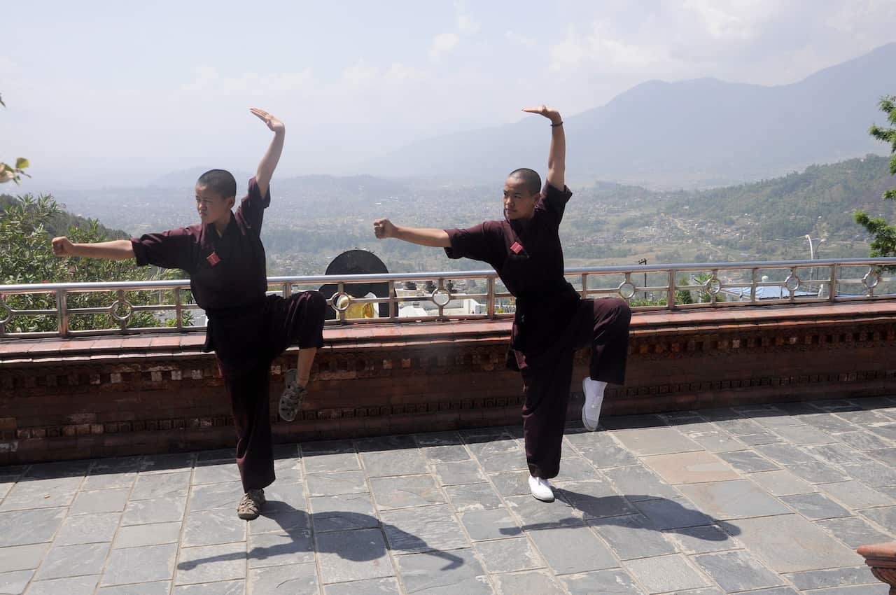 Jigme Wangchuk, 17 (left), and Jigme Konchok, 21 (right) perform drills at the Druk Amitabha Mountain nunnery. (Pradeep Bashy/The Washington Post)