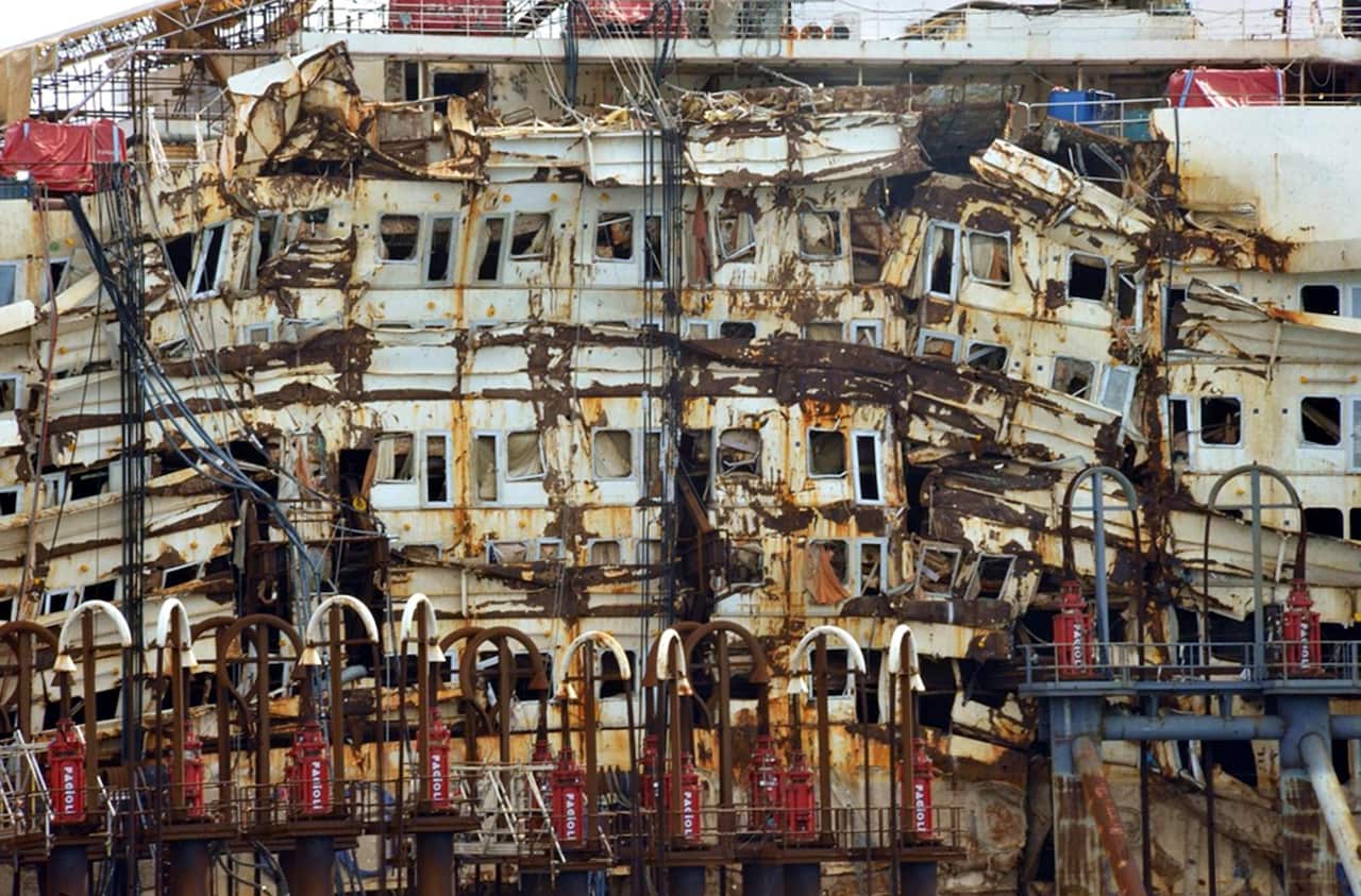 A view of the damaged decks of the former cruise ship Costa Concordia as it is pulled by tug boats to leave Voltri-Pra harbor in Genoa in 2015.