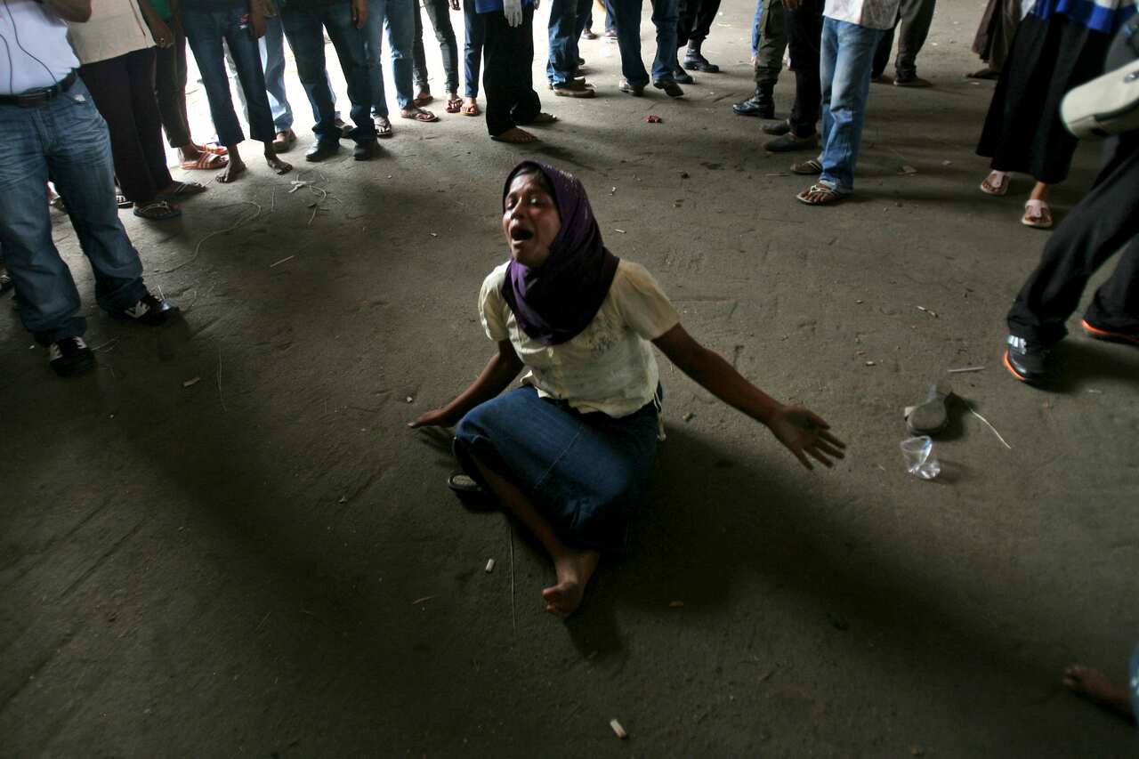 An ethnic Rohingya woman who said she got separated with her brother cries at a temporary shelter in Langsa, Aceh province, Indonesia(AP Photo/Binsar Bakkara)