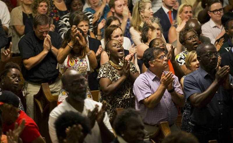 Parishioners applaud during a memorial service at Morris Brown AME Church for the people killed Wednesday during a prayer meeting inside a historic black church in Charleston, S.C., Thursday, June 18, 2015. (AAP)
