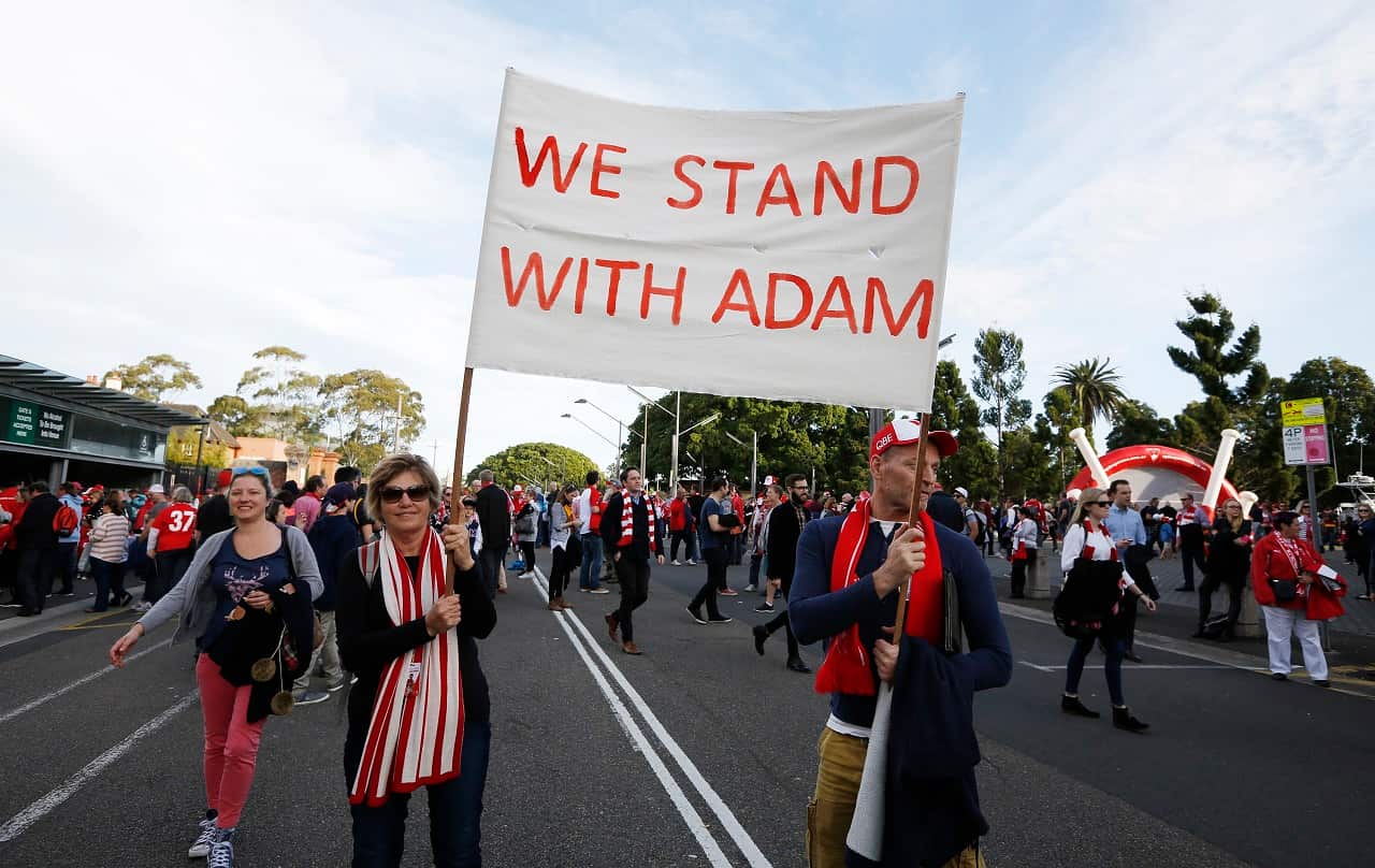 Sydney Swans supporters Wendy Twaddell (left) and Bruce Crabb hold a banner for Adam Goodes.