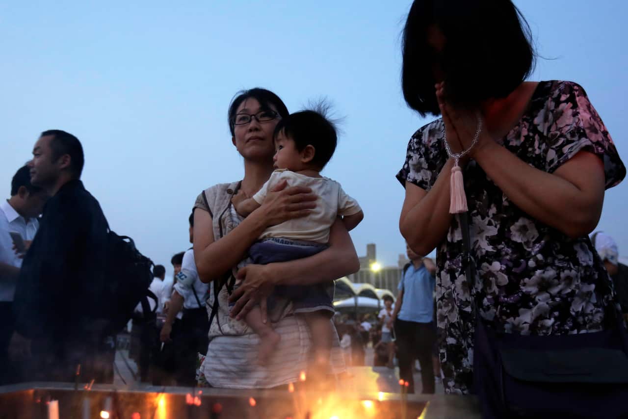 People offer prayers for victims of the atomic bombing during World War II in 1945, in front of a cenotaph at Hiroshima Peace Memorial Park (AAP)