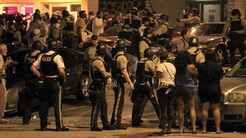 Officers move in to break up a crowd
