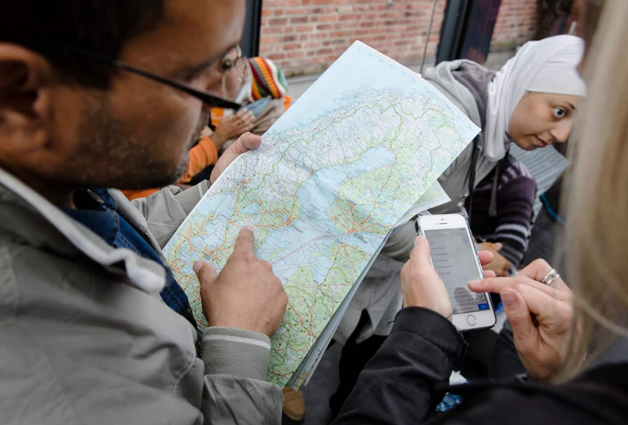 A refugee looks at a map of Sweden at Malmoe train station in Malmoe, Sweden.