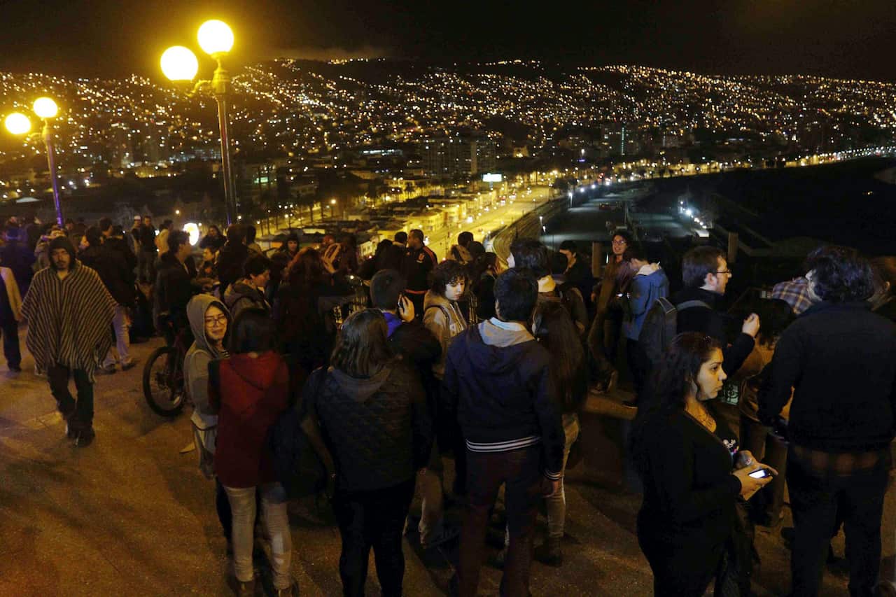 A group of people who left their houses in Valparaiso, Chile, late 16 September 2015, after a tsunami alert was issued for the earthquake of 8.3 on the Richter scale.  (EPA/RAUL ZAMORA)