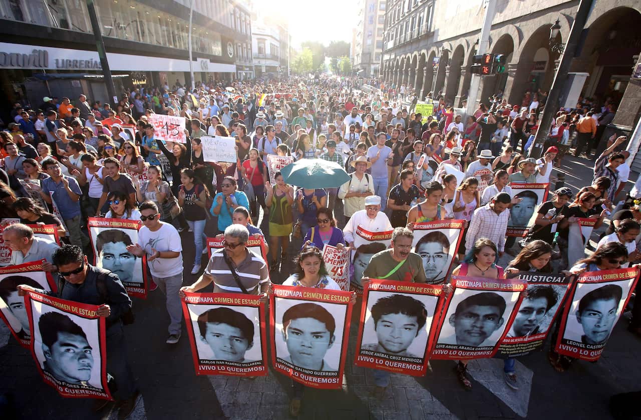 Thousands of people march asking justice as they hold banners of 43 missing Mexican students of the Ayotzinapa Rural Teachers' College during a rally marking one year anniversary since their disappearance, in Guadalajara, Mexico, 26 September 2015. (EPA)