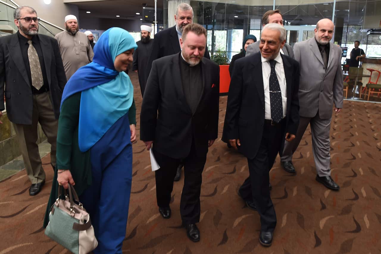 Father Rod Bower (centre) is worried proposed religious discrimination legislation will provide cover to break the law in the name of religion.