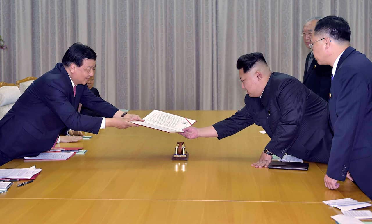 Liu Yunshan, a member of the Standing Committee of the Political Bureau of the Communist Party of China Central Committee, presents a signed letter from Chinese President and General Secretary of the CPC Central Committee Xi Jinping to North Korean leader