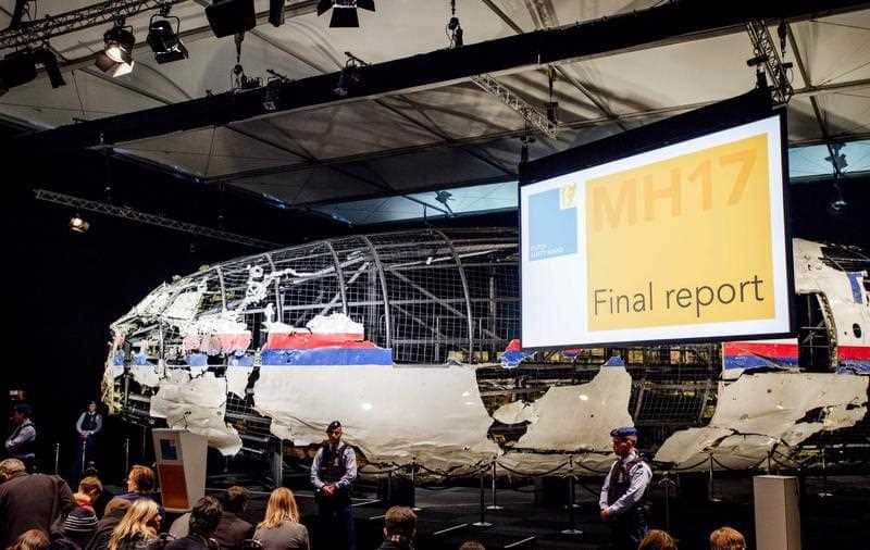 The rebuilt fuselage of Malaysia Airlines flight MH17 during a press conference to present the report findings of the Dutch Safety Board in Gilze Rijen, The Netherlands, 13 October 2015.