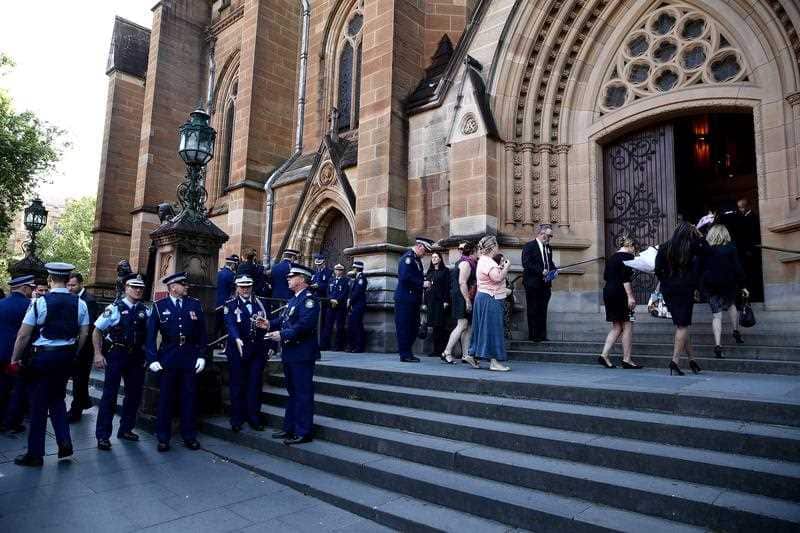 Mourners arrive for the funeral service of murdered police worker Curtis Cheng 